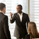 I typed the word “threaten” in the search on Shutterstock, and this is what came up. The original caption is “Angry African-American businessman threatens colleague, conflict between male workers at workplace, bullying and discrimination, black boss blames white employee responsible for failure, your fault”